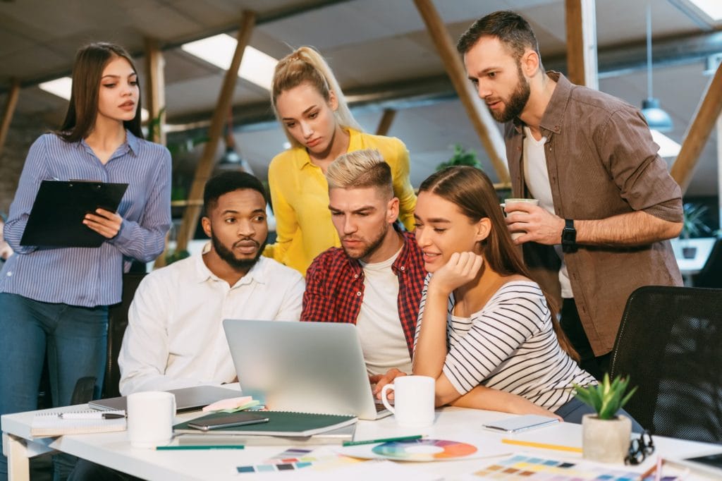 Freelance web designers brainstorming together in office